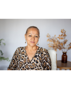 Woman sitting calmly with a gentle smile, representing finding support and hope during a stressful season
